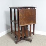 An Edwardian oak two tier revolving Bookcase with folding reading lectern, on casters, note
