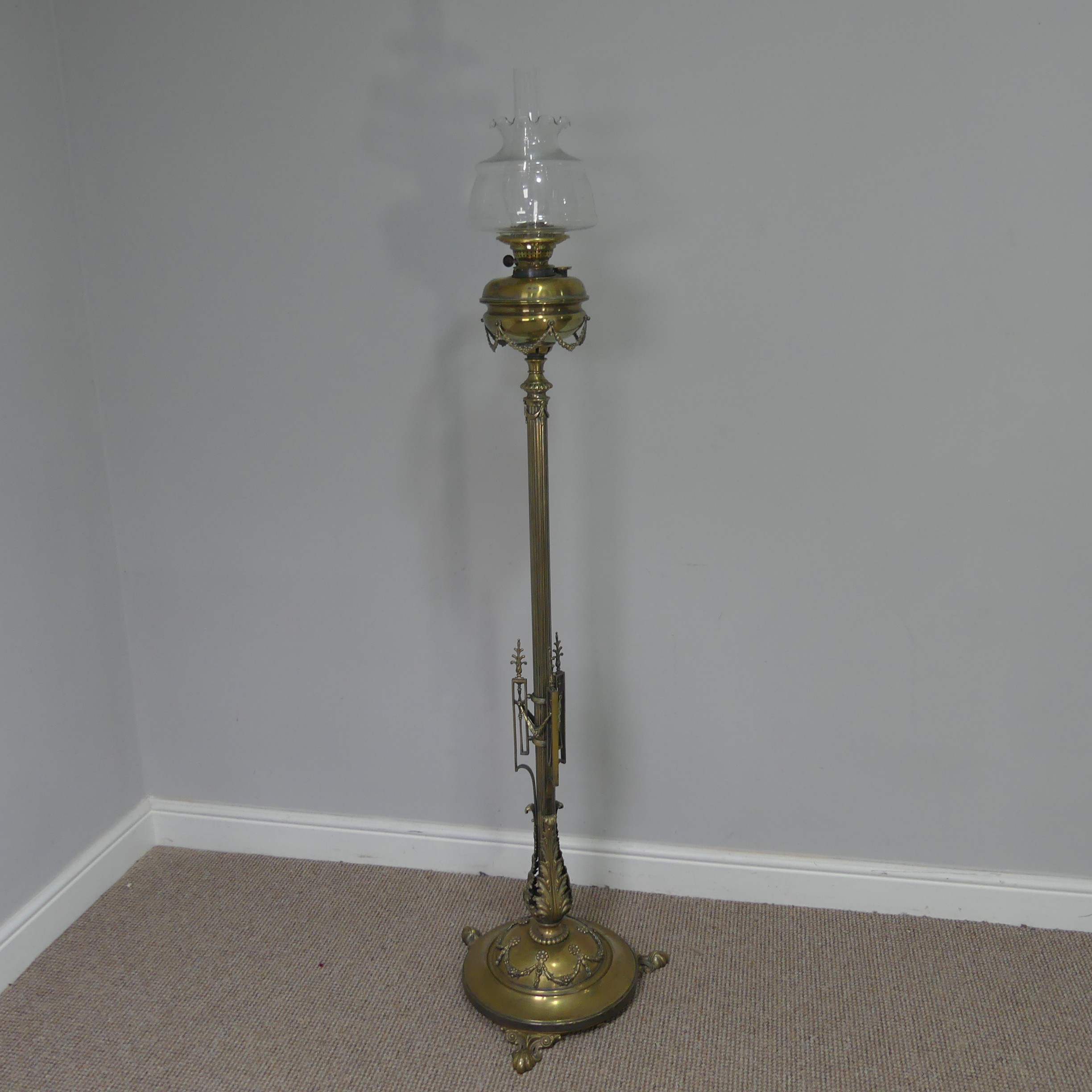 A Late 19thC/Early 20thC Brass standard Oil Lamp, with decorative reeded column, brass font and