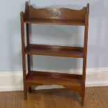 A walnut free standing three shelved Arts and Crafts inspired Bookcase, with open back and pierced