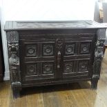 An antique carved oak Sideboard, the front with two panelled doors and caryatid pilasters, both side