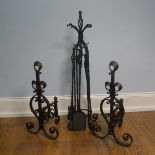 A pair of wrought iron arts and crafts Fire Dogs together with arts and crafts Fire Irons and Stand,