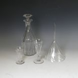 An antique glass wine funnel, together with two fluted glasses and shaped decanter, note smaller
