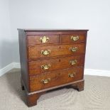 A George III provincial oak Chest of Drawers, of two short over three drawers all with decorative