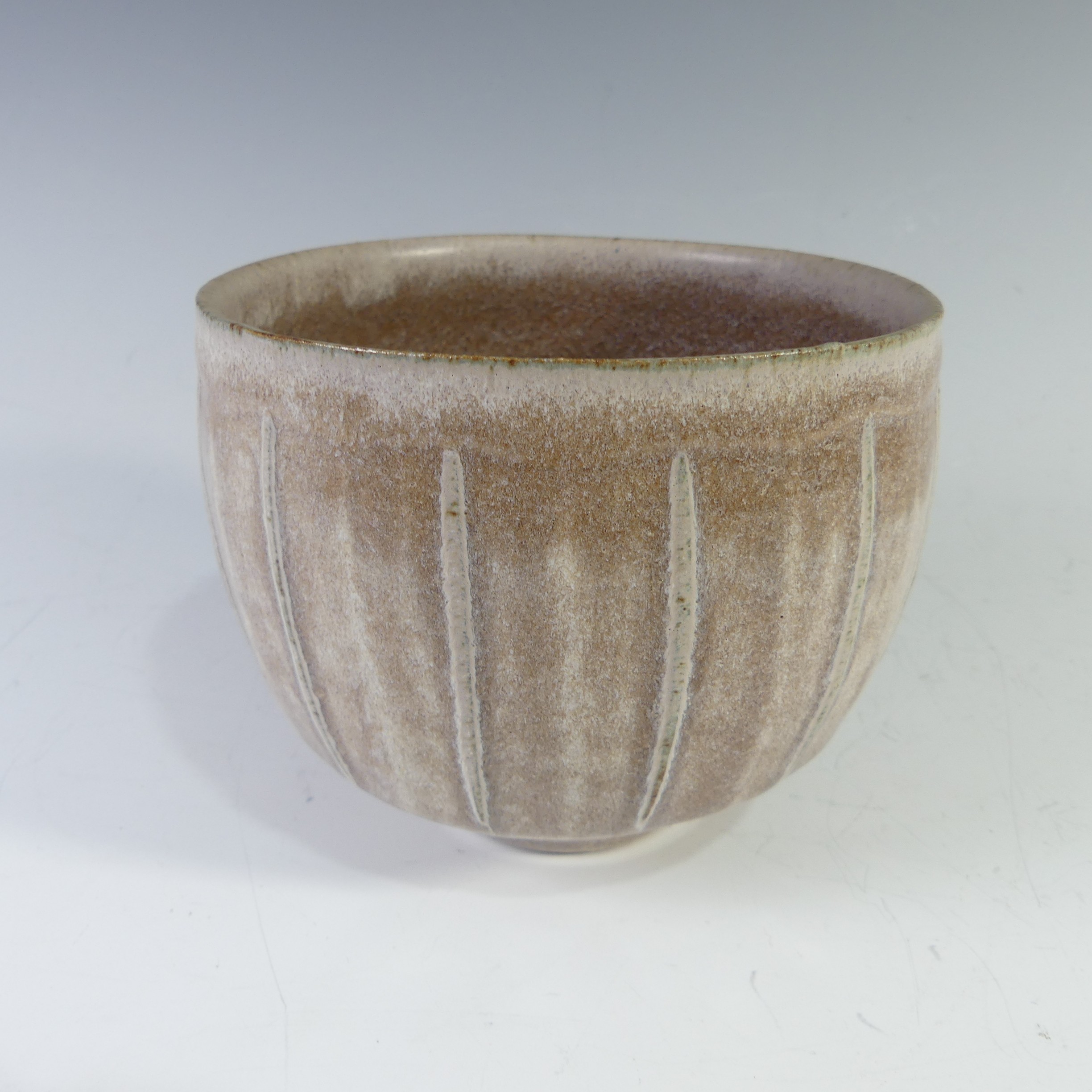 A David Leach studio pottery footed Bowl, of light brown ground with ribbed line decoration,