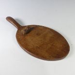 Robert 'Mouseman' Thompson (1876-1955): An English carved Oak Cheese Board, of standard form, with