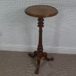 A late Victorian mahogany plant stand/tall wine table, circular top upon turned column supported