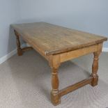 A 19thC farmhouse style pine Kitchen Table, rectangular top set upon four turned legs supported by