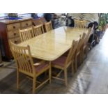 An Ercol windsor extending Dining Table together with eight matching penn classic Dining Chairs