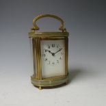 A French gilt brass and green onyx marble Carriage Clock timepiece, of five glass oval form, the