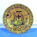 A Poole pottery aegean Charger, in Danish decorated with a viking ship, Diameter 41 cm x Height 6