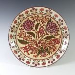 A Zsolnay Pecs wall Plate, decorated with painted floral sprays, note small chip to plate rim and
