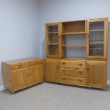 A late 20thC Ercol elm Sideboard with pair of glazed cabinets flanking central open shelves over