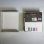 A collection of Great British mint Stamps, in five cases with presentation packs with issues to £10,