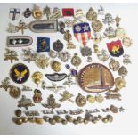 A collection of military Cap Badges inc; O.T.C, Gurkha, Royal Engineers, etc. Together with a