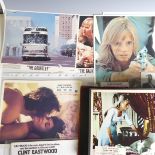 A quantity of Clint Eastwood movie Lobby Cards, including ; an album with taped down sets consisting