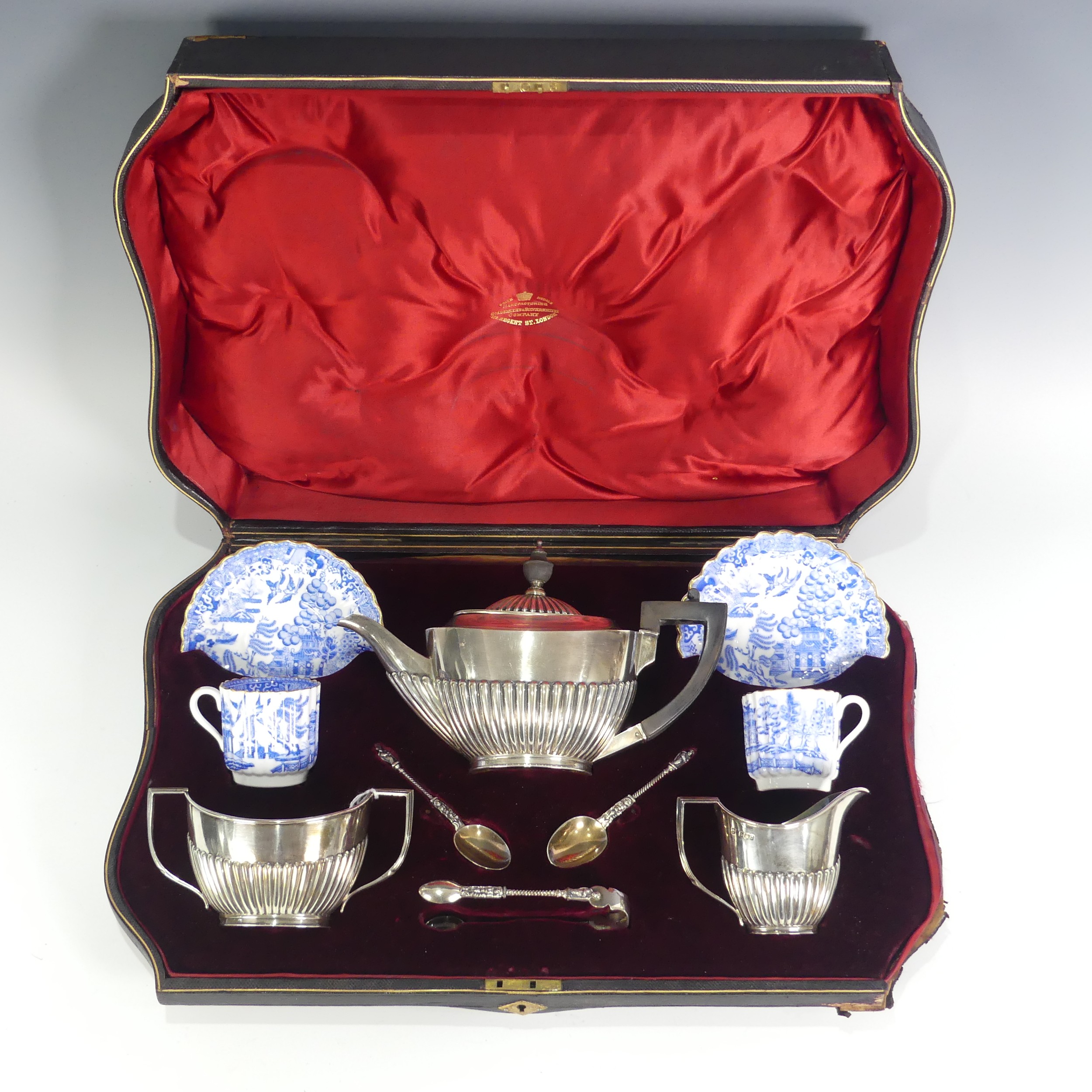 A cased Victorian silver three piece tete-a-tete Tea Set, by Goldsmiths & Silversmiths Co.,