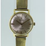 An 18ct gold Omega Seamaster De Ville Wristwatch, the silvered dial with gilt baton markers and