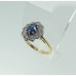 A sapphire and diamond cluster Ring, the central oval facetted sapphire approx. 5.6x4.1mm,