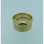 A wide 9ct gold gold Band, with foliate decoration, Size L, 5.9g.