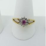 A small ruby and diamond cluster Ring, mounted in 18ct yellow and white gold with split shoulders,