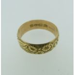 An 18ct yellow gold Band, with foliate decoration, hallmarked Chester 1902, Size V½, 6.2g.