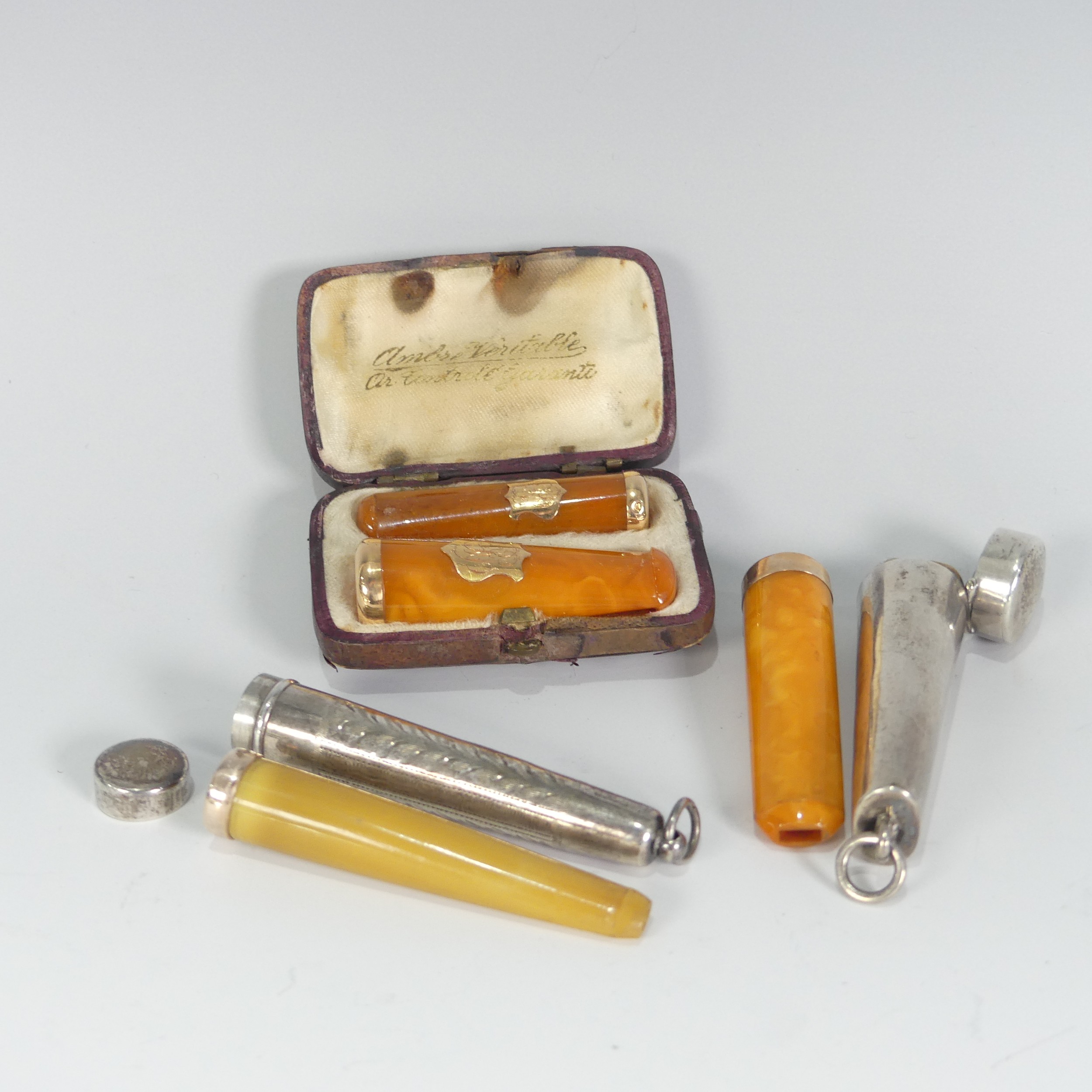 A pair of early 20thC gold mounted amber Cheroot Holders, in fitted leather case, together with a