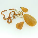 A string of oval butterscotch Amber Beads, as found, loosely threaded on replacement string, 43