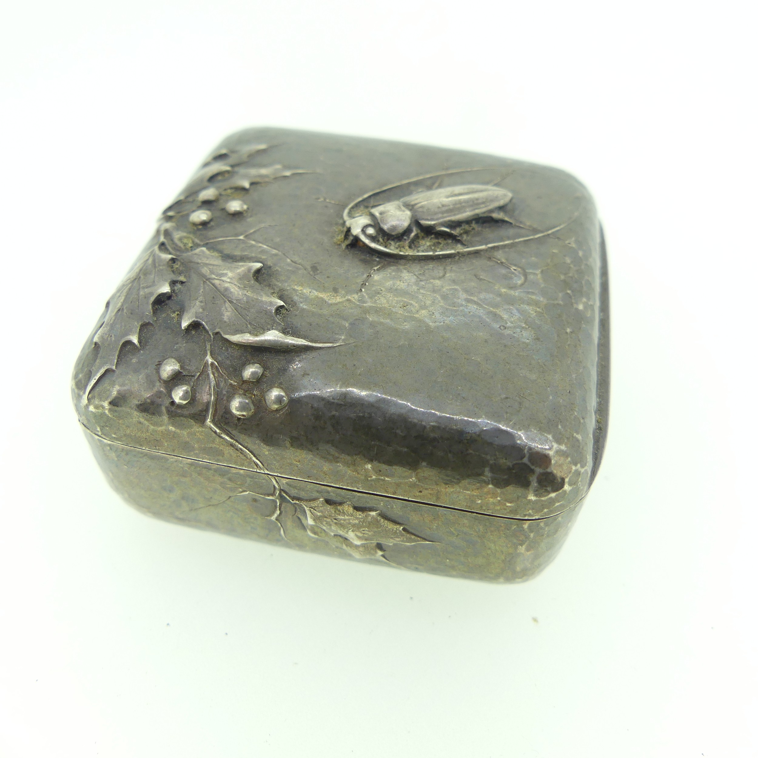 A French silver Pot, of square form with hammered decoration, the hinged cover with applied holly