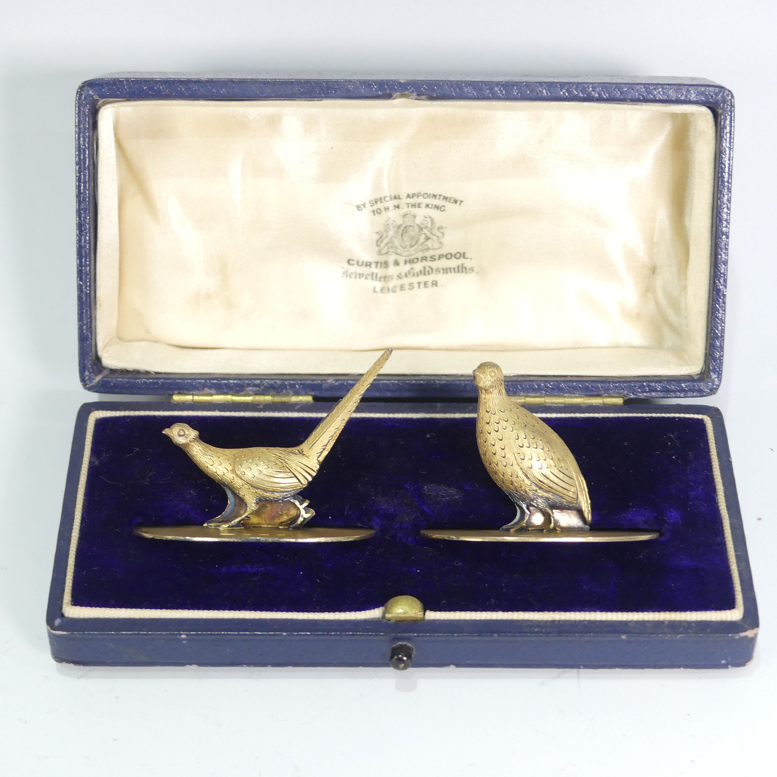 A cased pair of George V silver gilt Menu Holders, by C & C Hodgetts, hallmarked Birmigham, 1913, in
