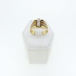 A yellow gold Ring, with split reeded shoulders, the front vertically set three white pastes,