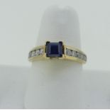 A sapphire and diamond Ring, the central square sapphire 4.65mm wide, with five brilliant cut