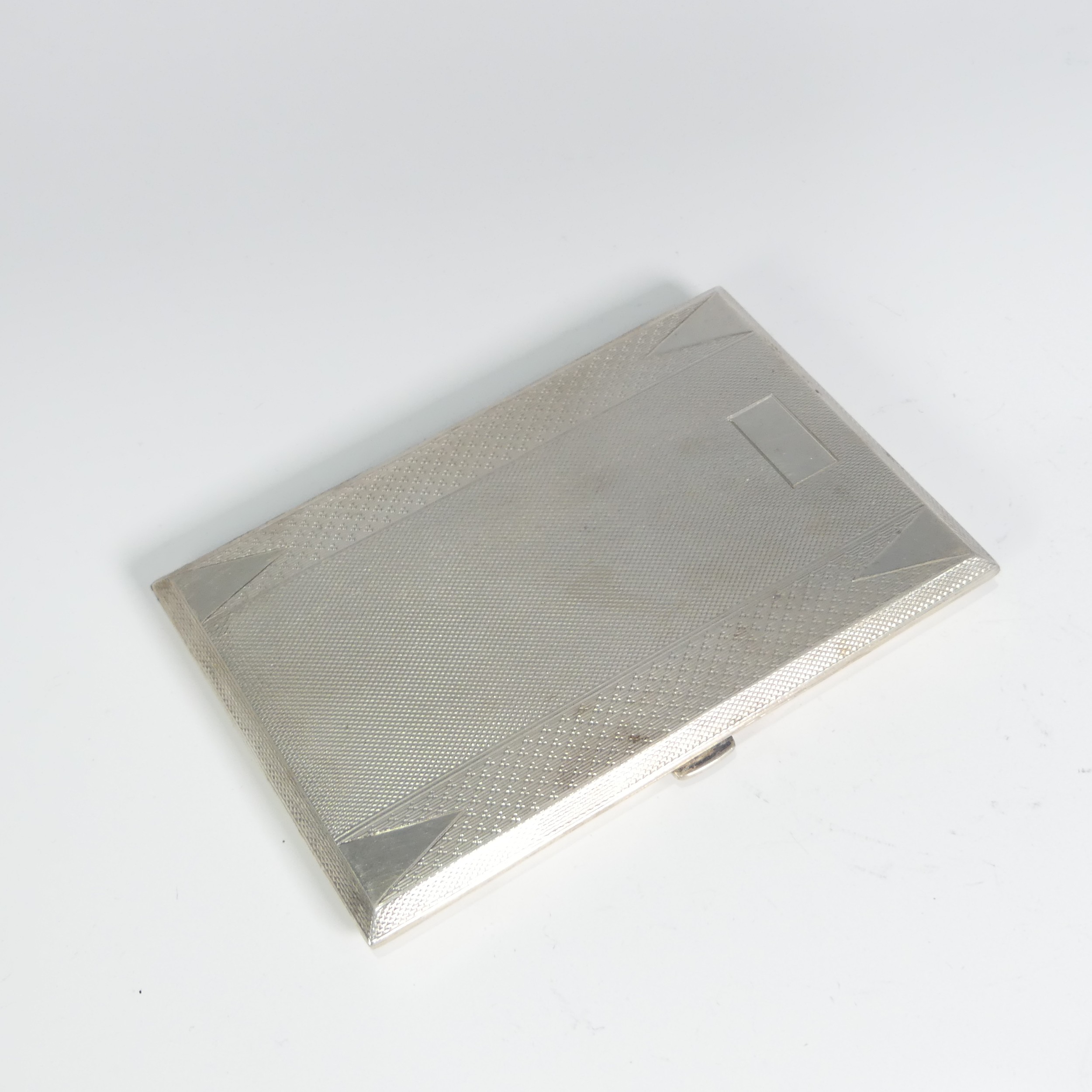 A George V silver Cigarette Case, by S W Goode & Co., hallmarked Birmingham 1933, of hinged