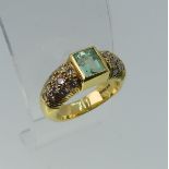 An 18ct yellow gold, Topaz and diamond Dress Ring, the central rectangular facetted topaz, approx.