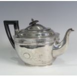 A George III silver Teapot, hallmarked London, 1805, of oval form with bright cut decoration, wooden