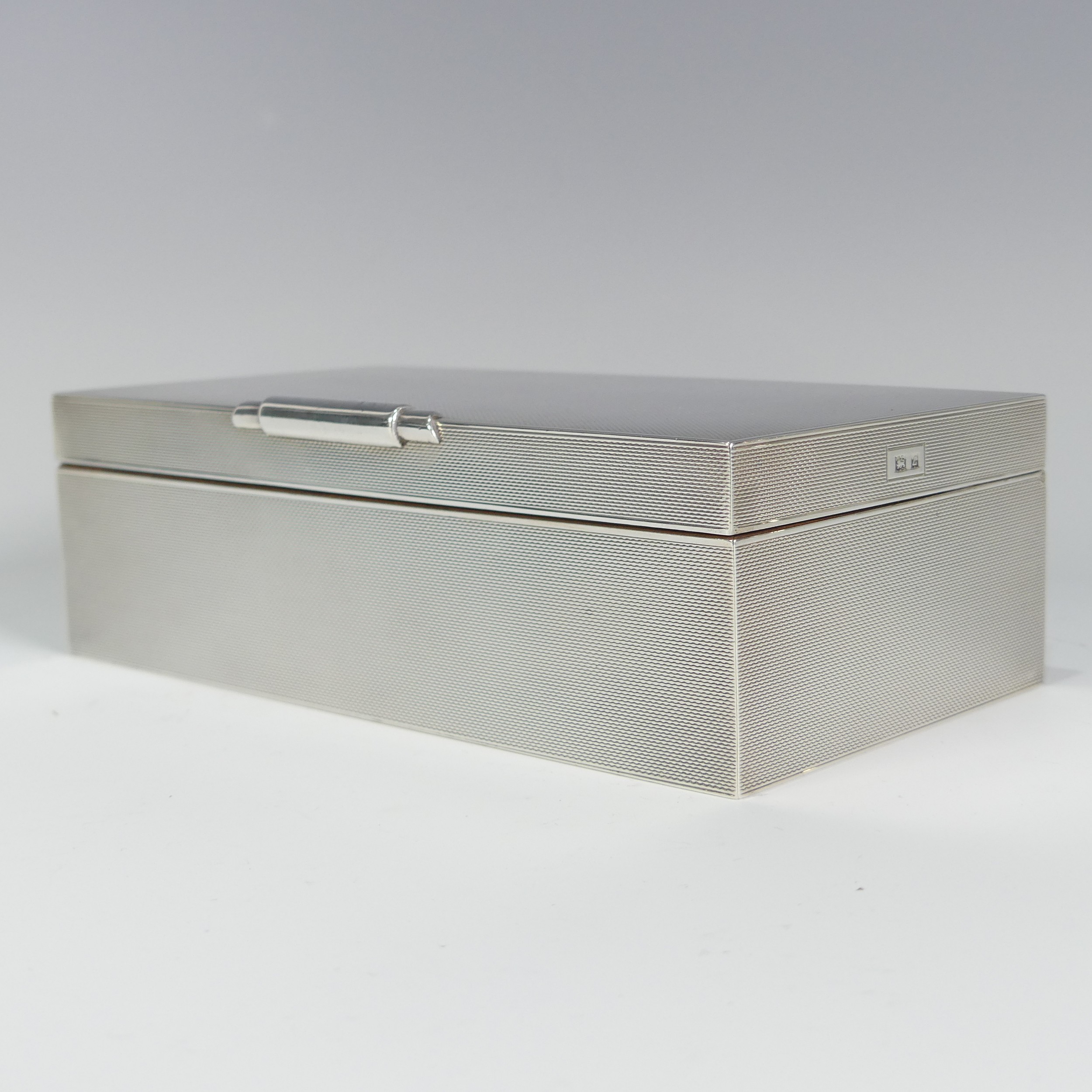An Elizabeth II silver Cigarette Box, by W H Manton Ltd., hallmarked Birmingham 1960, of rectangular