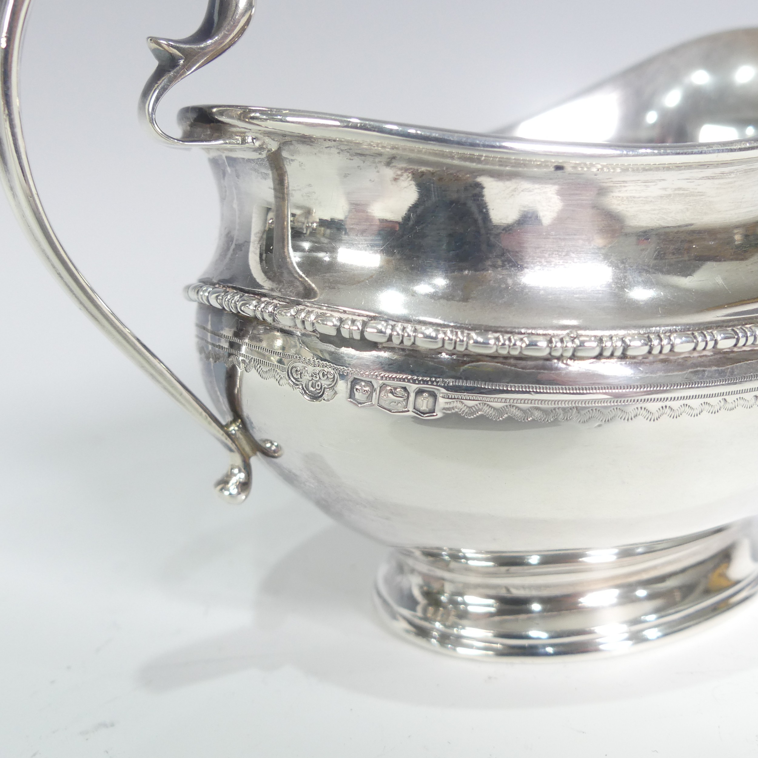A George V silver three piece Tea Set, by Goldsmiths & Silversmiths Co Ltd., hallmarked Sheffield - Image 4 of 14