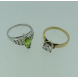 A 9ct white gold Ring, set with a facetted navette shaped peridot, Size N, together with a cubic