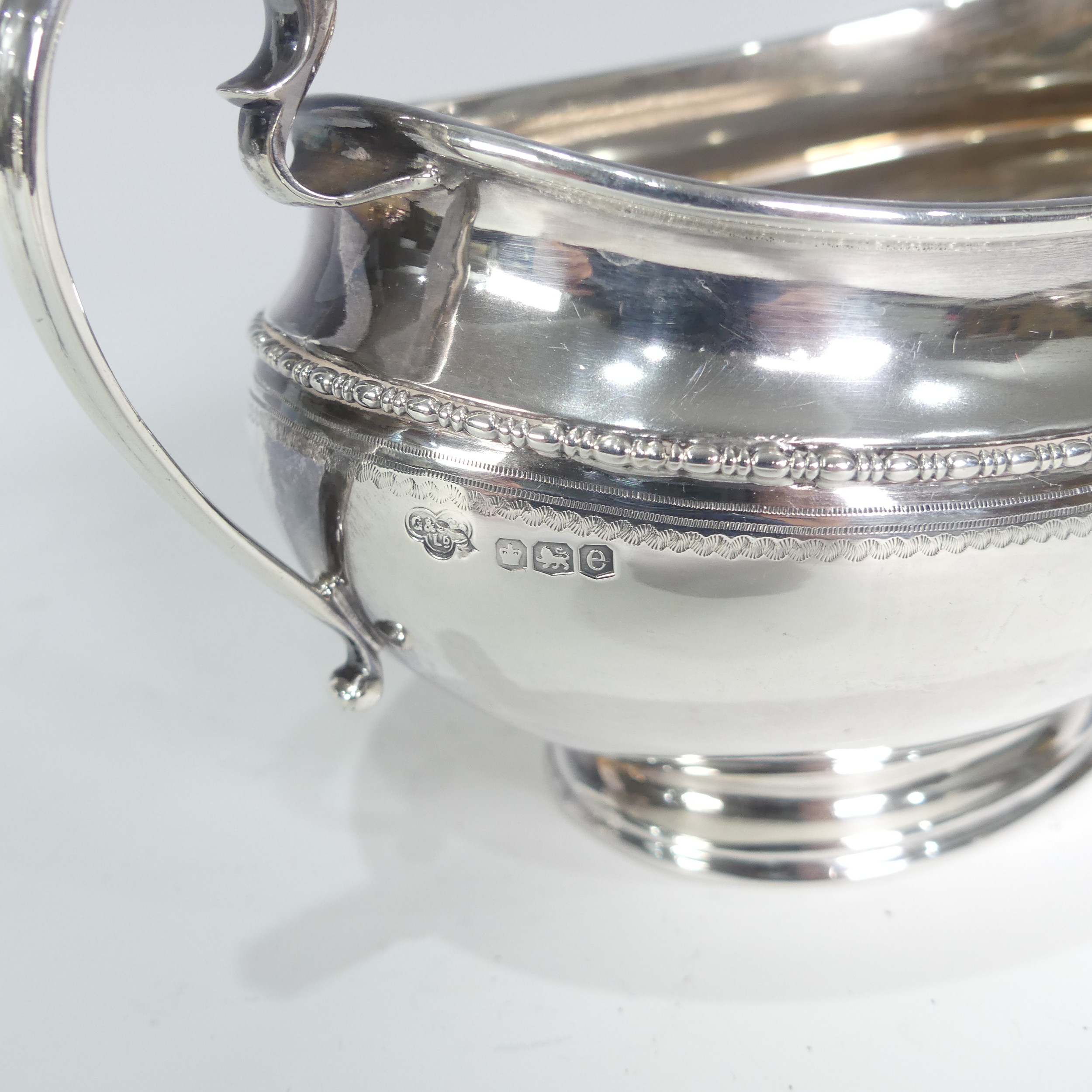 A George V silver three piece Tea Set, by Goldsmiths & Silversmiths Co Ltd., hallmarked Sheffield - Image 7 of 14