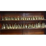 A collection of approximately one hundred antique brass crinoline 'Lady Bells', sand cast, various