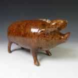 An early 19thC Rye pottery style Sussex Pig, in brown dotted glaze, with detachable head,
