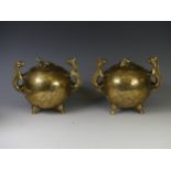 A Pair of Chinese twin handled brass Censors, decorated with a carved dragon and clouds on one side,