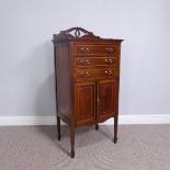 An Edwardian mahogany inlaid music Cabinet, with three drawers over one cupboard, raised on square