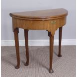 A George II mahogany demi-lune Tea Table, with plain folding top, deep frieze, on turned legs with