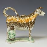 A late 18th/early 19thC prattware Cow Creamer, decorated in ochre and umber slip modelled with a
