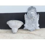 A wall-mounted lead water Fountain in the shape of a lions head, above basin/reservoir, W 42 cm x