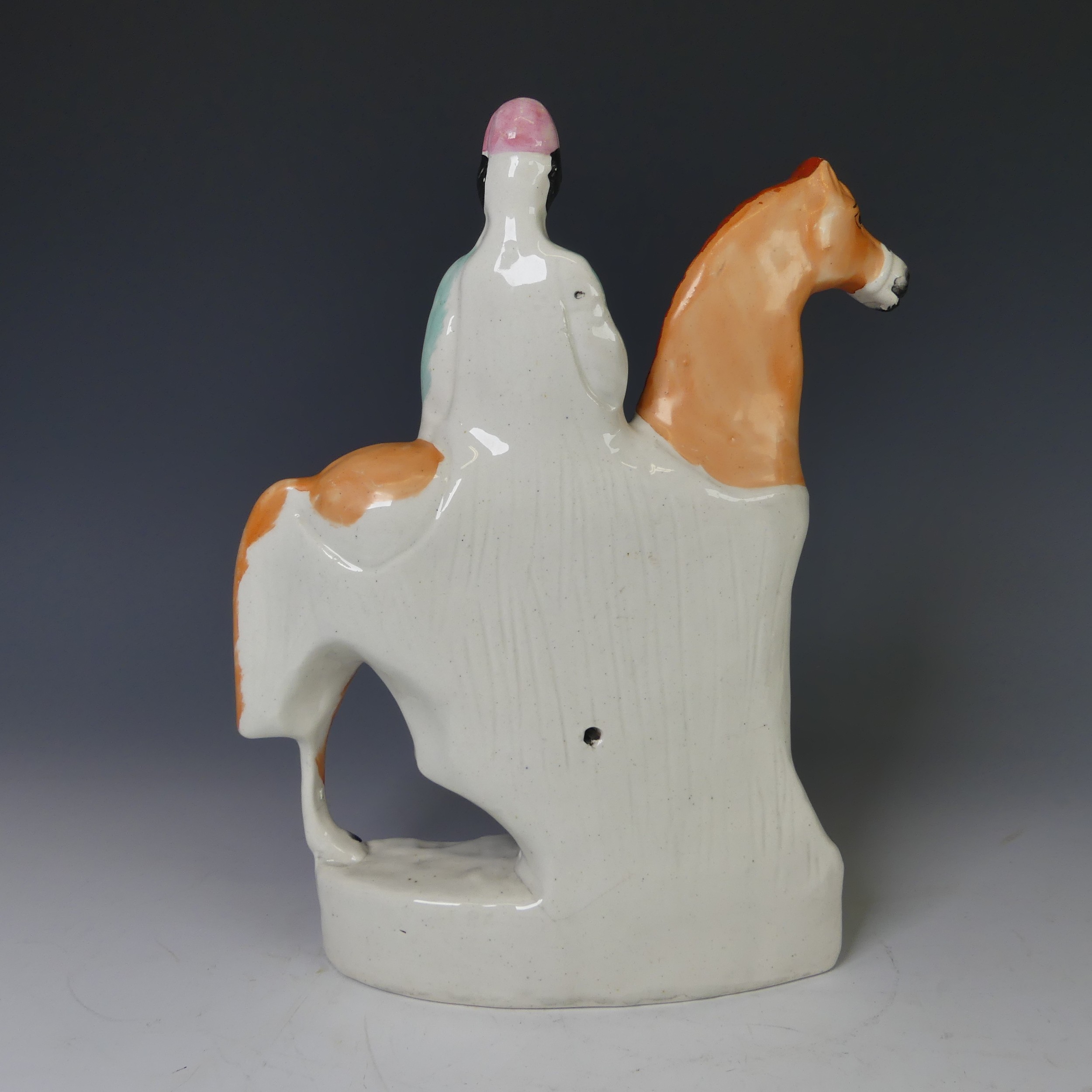 An antique Staffordshire pottery figure of a Jockey on Horseback, the rider with pink hat and blue - Image 3 of 9