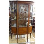 An Edwardian mahogany inlaid glazed Display Cabinet, with curved glass sides and glazed front door