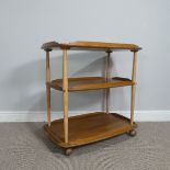 A Retro three-tiered Ercol Tea Trolley, upon casters, W 70 cm x H 74 cm x D 43 cm.