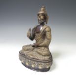 An antique Sino-Tibetan gilt bronze figure of the Buddha, seated in dhyanasana on a lotus base,