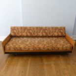 A retro 1970s teak three person Sofa / Day Bed, floral upholstered hinged backrest and seat cushion,